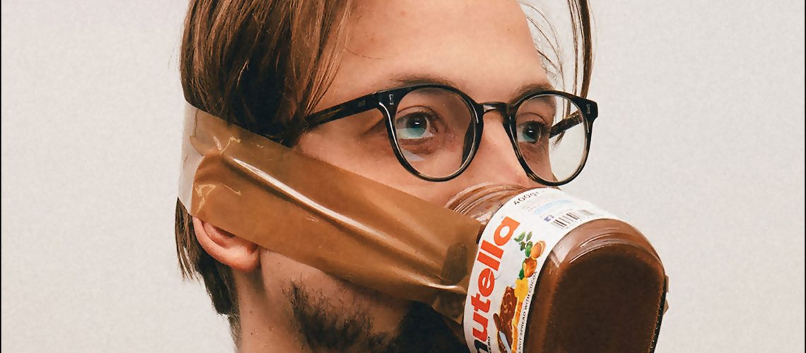 man wearing a jar of nutella as face mask